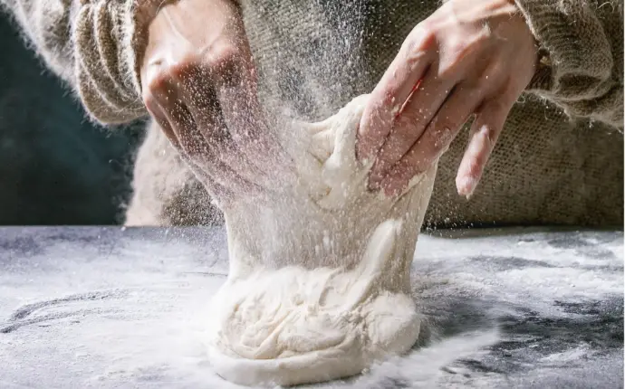hands kneading bread